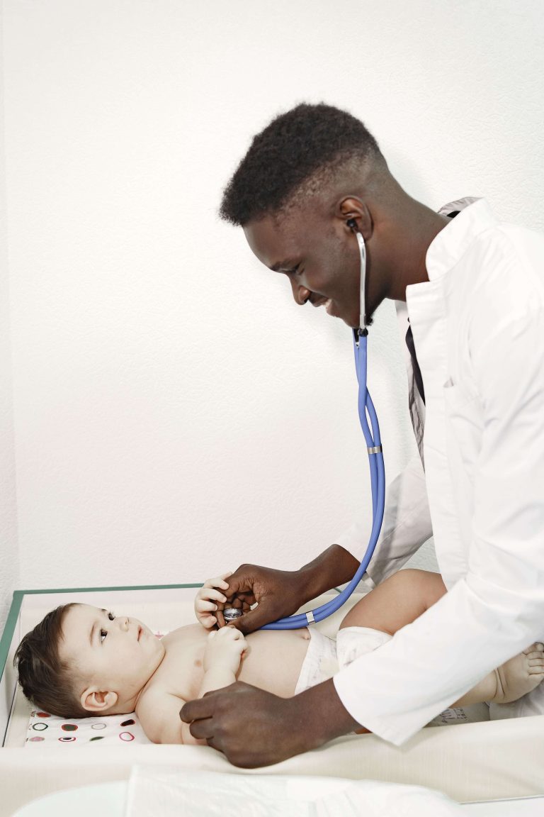 black doctor providing care for new born baby