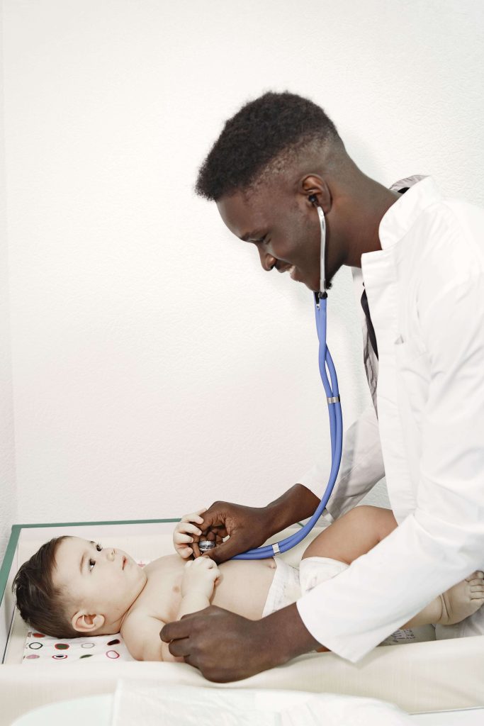 black doctor providing care for new born baby